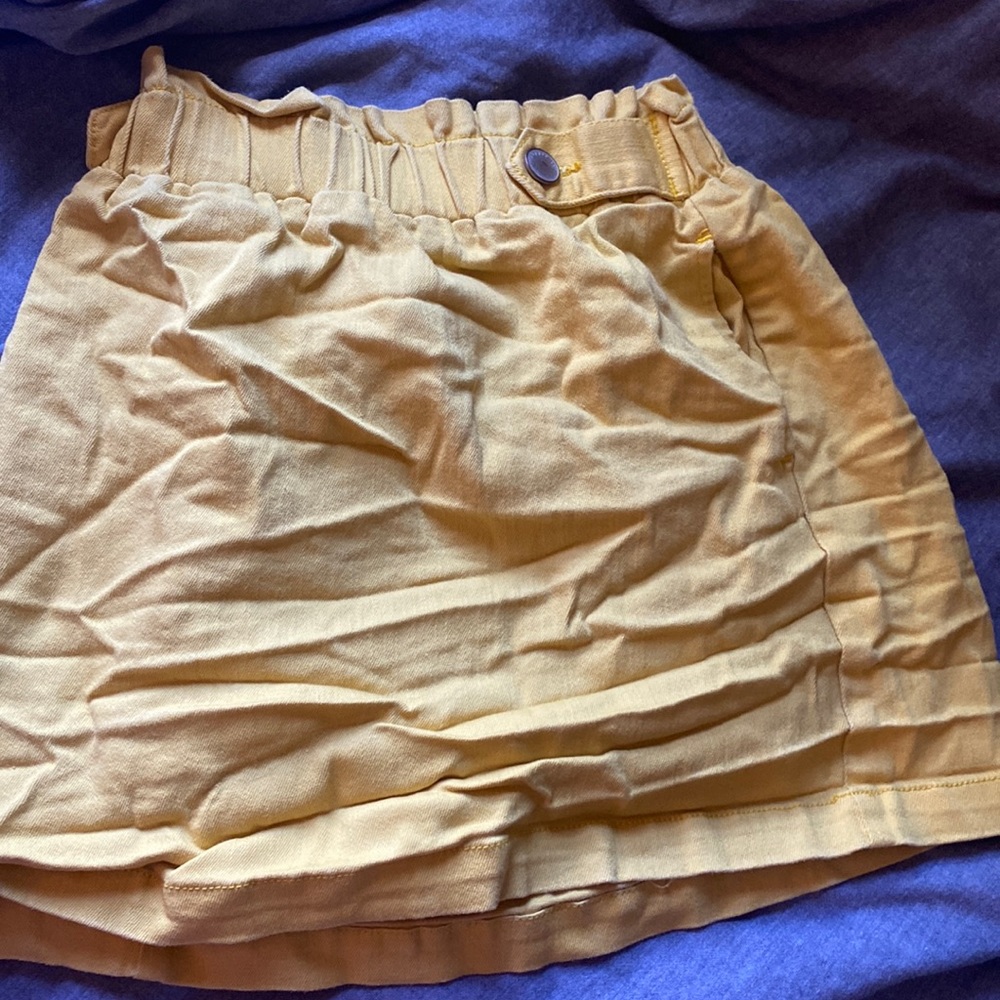 Copper Key worn yellow skirt
